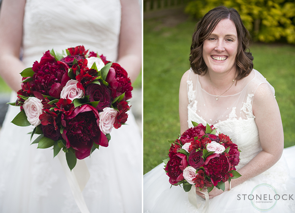 The bride poses with her red flower bouquet 