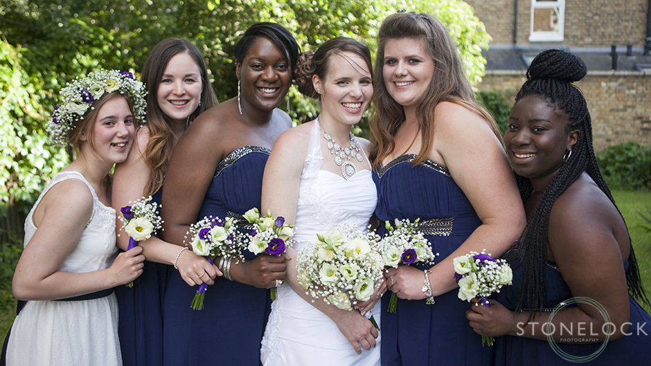 The bride with her bridesmaids leaning in close