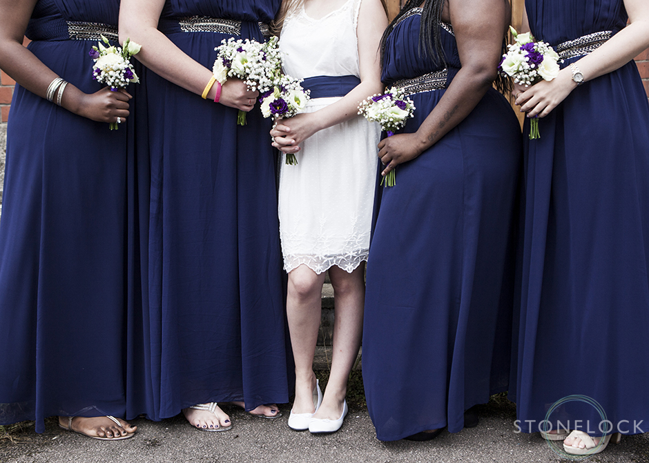 The bridesmaids hold their flowers