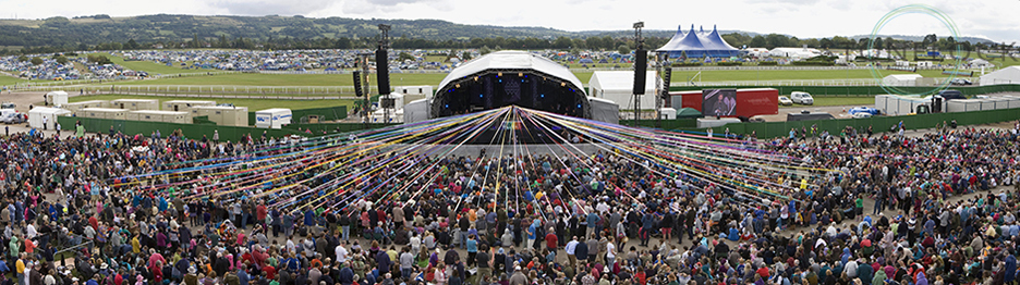 The Sunday morning communion service held at MainStage at Greeneblt Arts Festival, the crowds hold ribbons which feed back towards the centre of the stage
