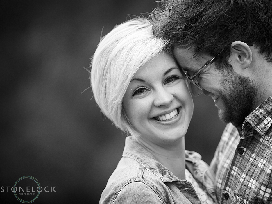 A man leans his head onto his girlfriend's during an engagement shoot in Bristol, the photo is in black and white