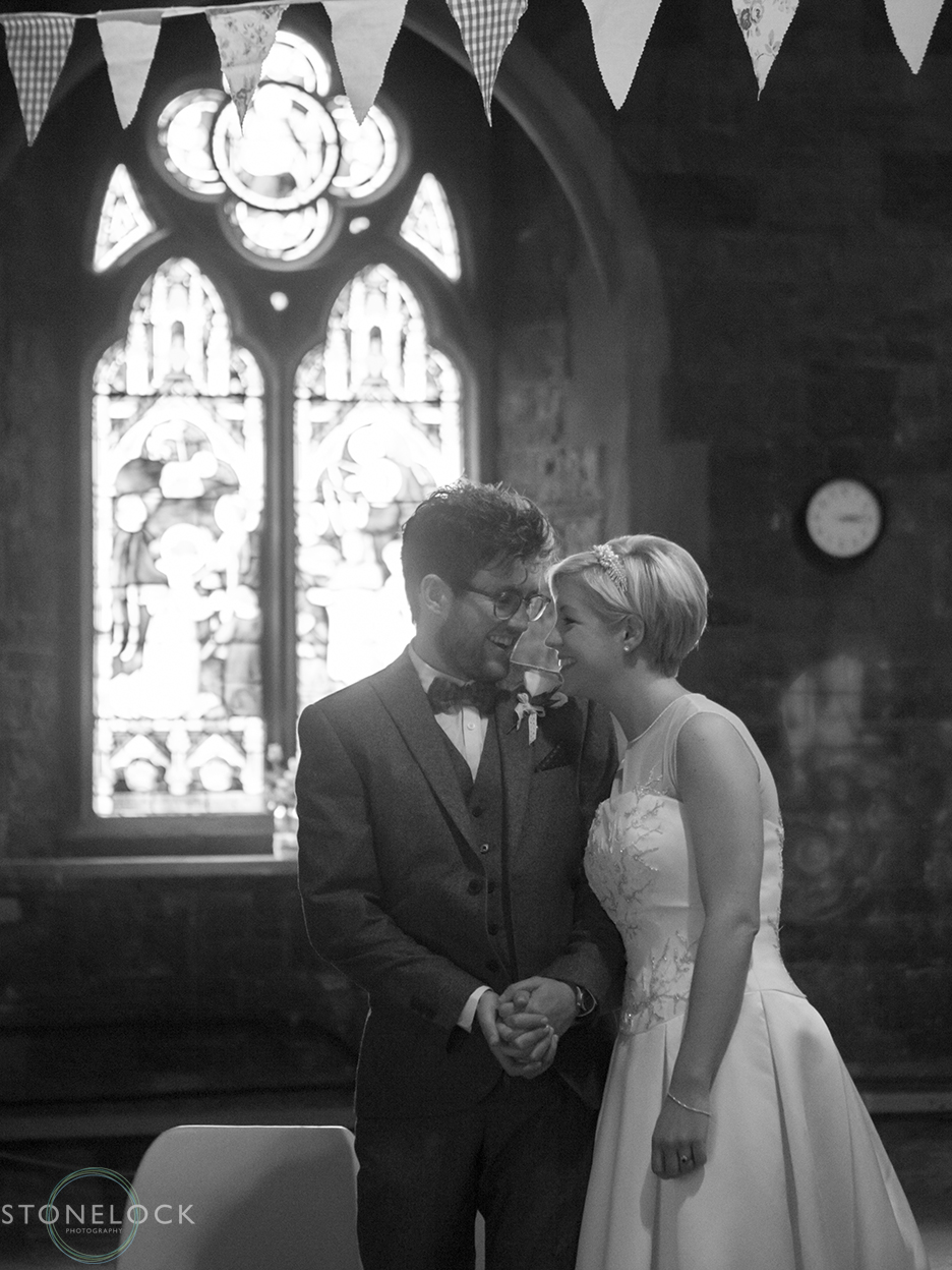 Wedding photography of a quiet moment between the bride and groom after they have said their wedding vows at Woodlands Church in Bristol