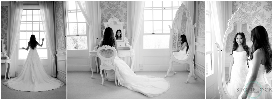 Bride getting ready for her wedding gin a hotel room, she is looking in a mirror