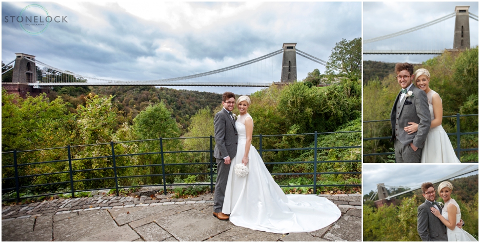 A wedding photo of a bride and groom in front of the Clifton Suspension Bridge in Bristol