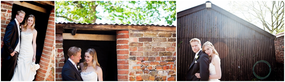 a bride and boom pose for photos in the doorway of a red brick shed