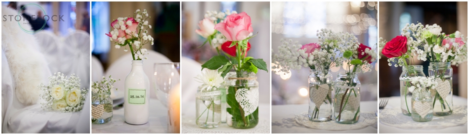 flowers in old jars sit on the tables at a wedding reception