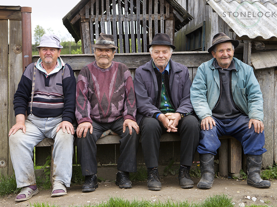 Men sitting outside Ieud village, Maramures, Romania