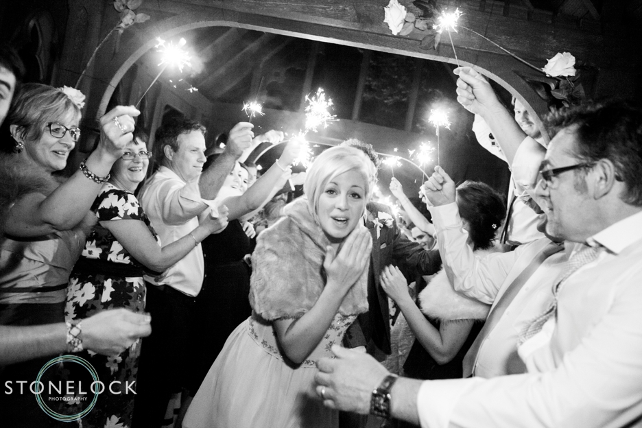 A Guide to Your Wedding Day Timeline: A sparkler exit by the Bride & Groom