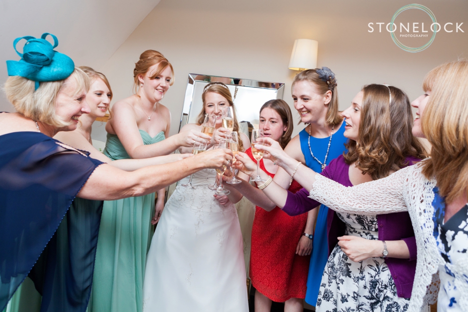 Bride with her best friends before her wedding at Bassmead Manor Barns in Cambridgeshire