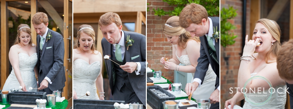 the bride and groom try out the s'more's bar at their wedding at Bassmead Manor Barns in Cambridgeshire