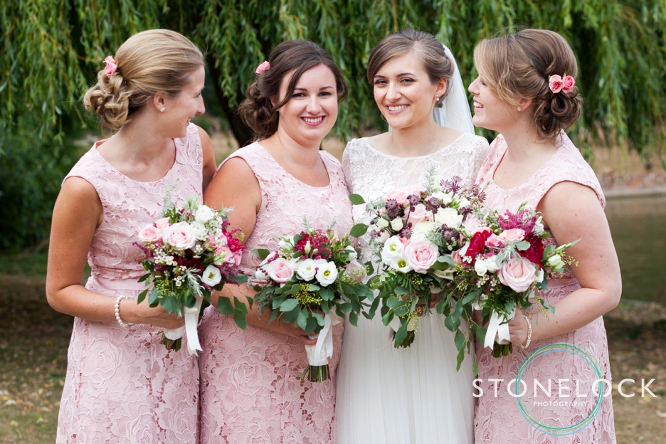 The bride and bridesmaids pose for photographs at a wedding reception at Forty Hall in Enfield, London