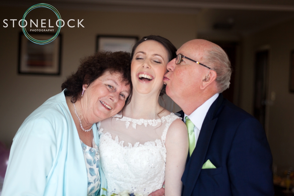 Top tips for great wedding photography, a bride with her parents