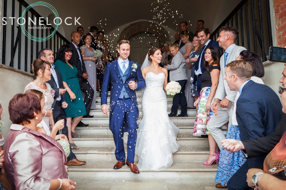 Farnham Castle, Surrey, Wedding photography, confetti being thrown at the bride & groom