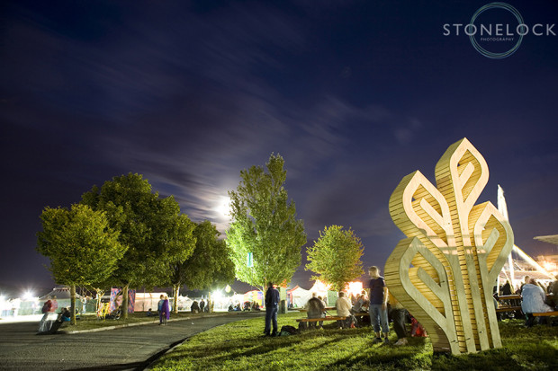 The Greenbelt Arts Festival sculpture shot at night time with a slow shutter speed to show movement of people and clouds in the sky